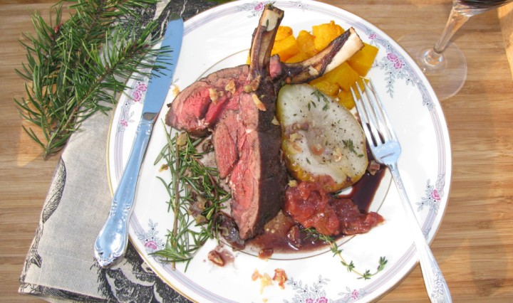 Roasted rack of venison with rosemary on the side.